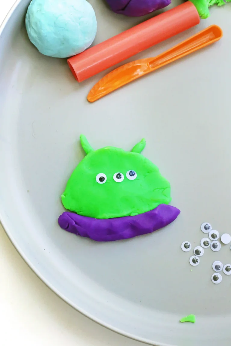 a Toy Story Alien Playdough Tray with an alien made out of playdough