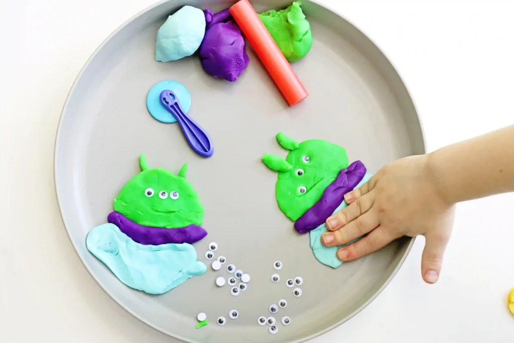a Toy Story Alien Playdough Tray with an alien made out of playdough