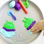 a Toy Story Alien Playdough Tray with an alien made out of playdough