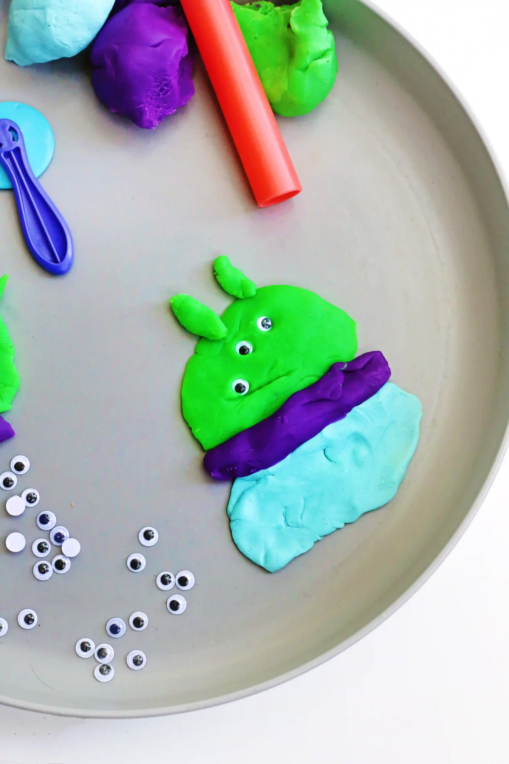 a Toy Story Alien Playdough Tray with an alien made out of playdough