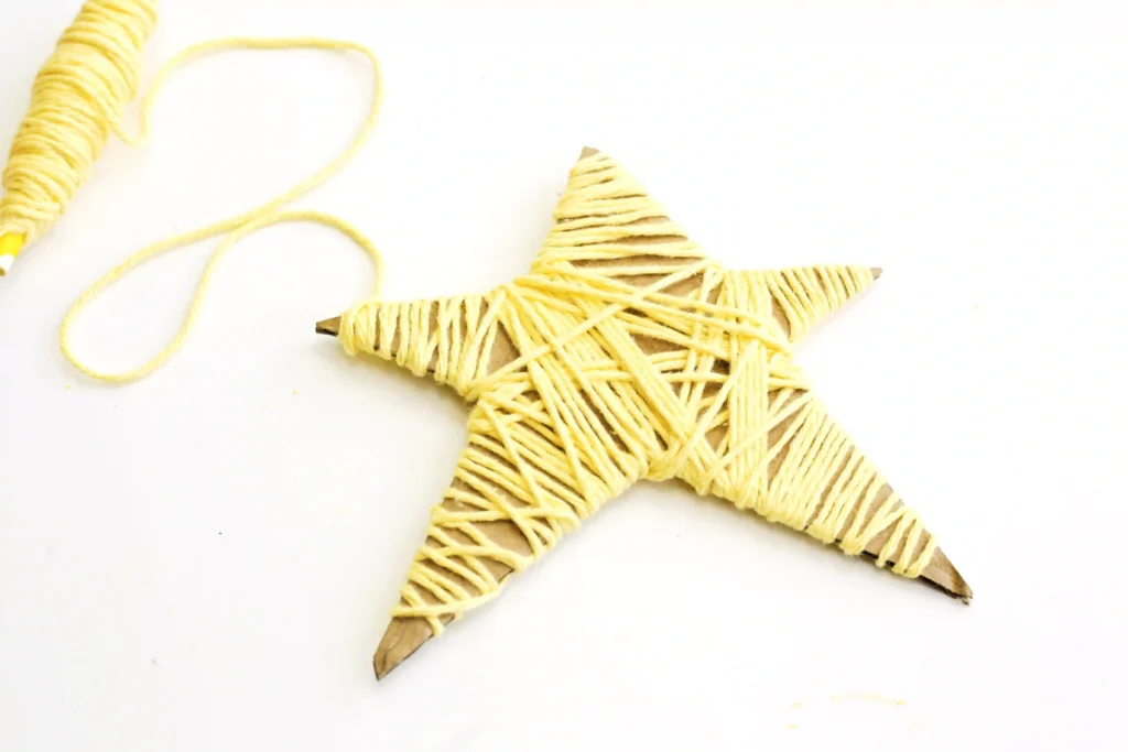 a Yarn-Wrapped Shooting Star Craft that is cardboard cut into a star and wrapped with yellow yarn