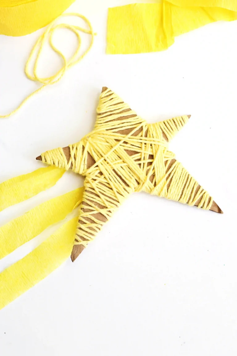 a Yarn-Wrapped Shooting Star Craft that is cardboard cut into a star and wrapped with yellow yarn and has yellow streamers attached