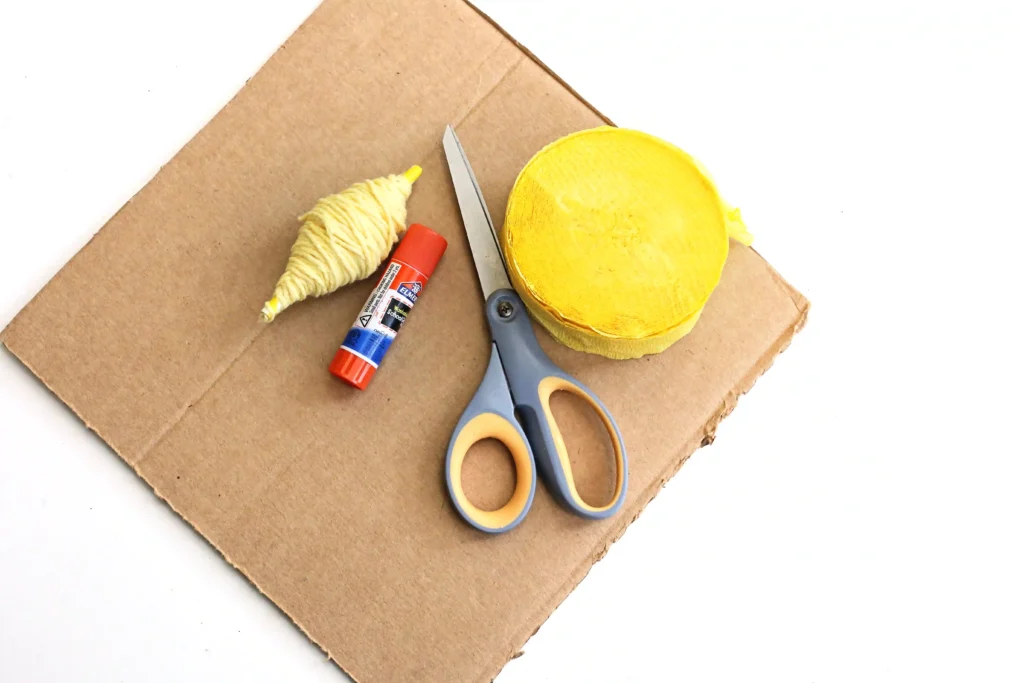 supplies for the shooting star craft- cardboard, yellow string, glue, scissors, and yellow streamer