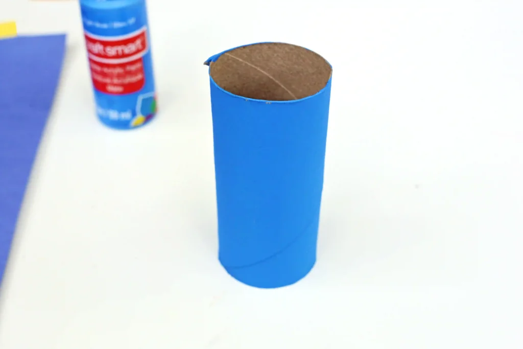 a toilet paper roll painted blue