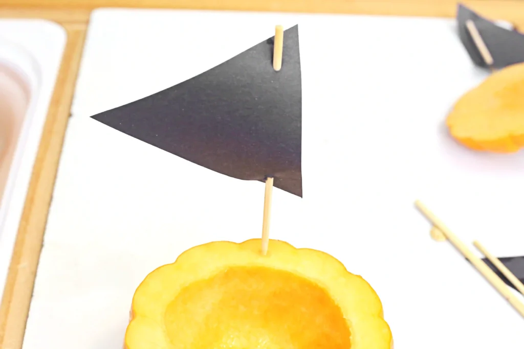 a sale made out of construction paper and a skewer