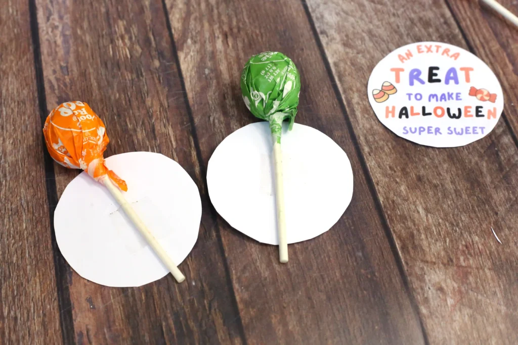 a lollipop taped to the back of a halloween tag