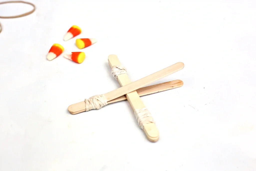 popsicle sticks attached using rubber bands