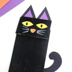 a paper bag painted black and decorated to look like a cat