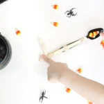a kid using a catapult made out of a spoon to fling candy corn