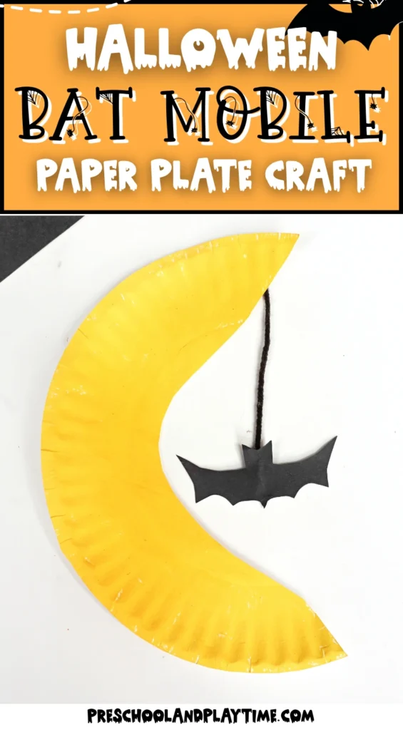 a paper plate cut and painted to look like the moon with a bat hanging down