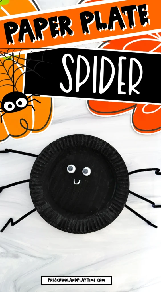 a paper plate painted black and decorated to look like a spider
