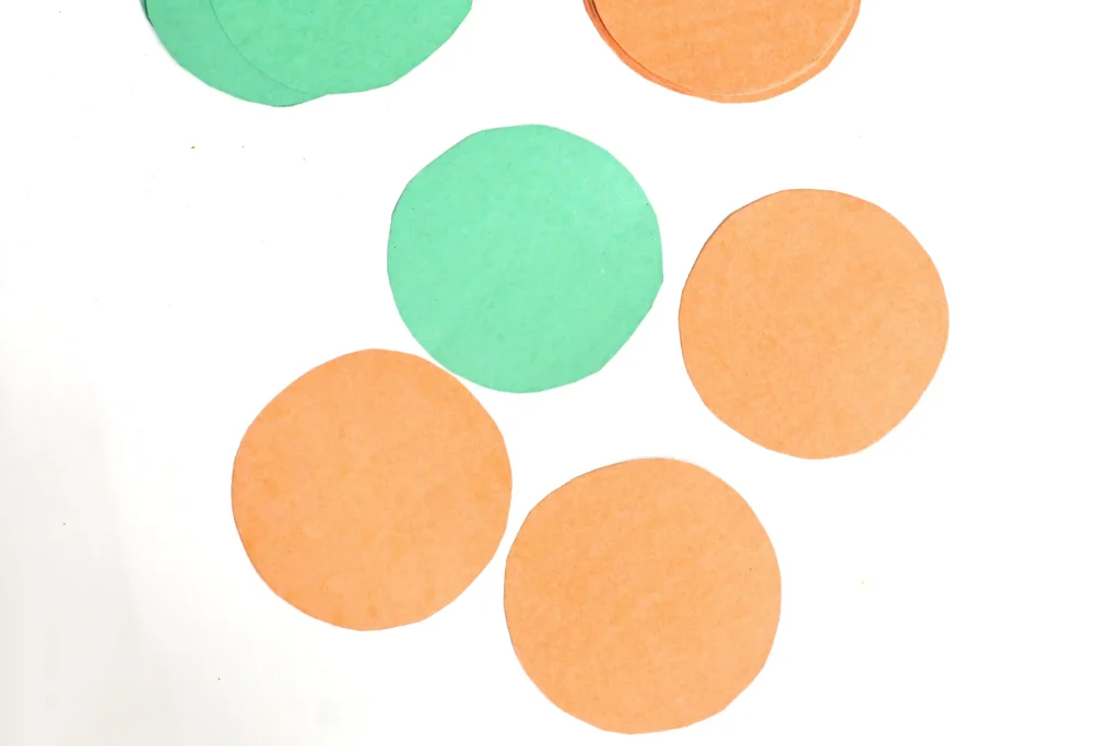 orange and green circles cut out of construction paper