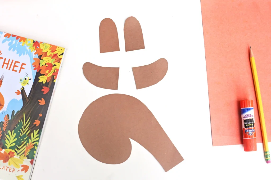 squirrel arms, ears, and a tail cut out of brown construction paper