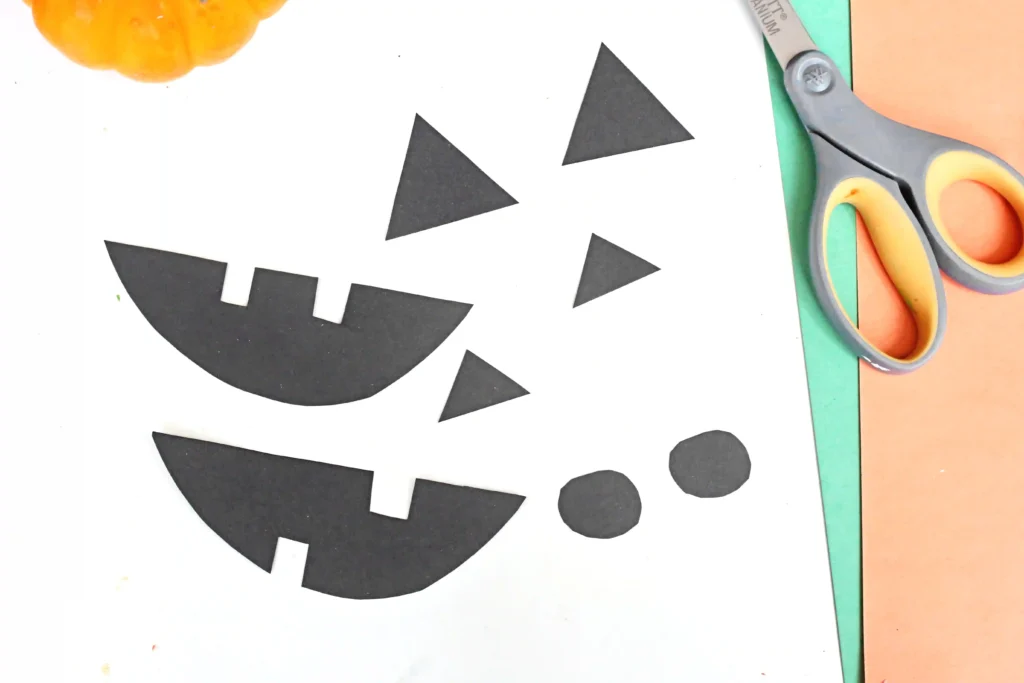 jack-o-lantern faces cut out of black construction paper