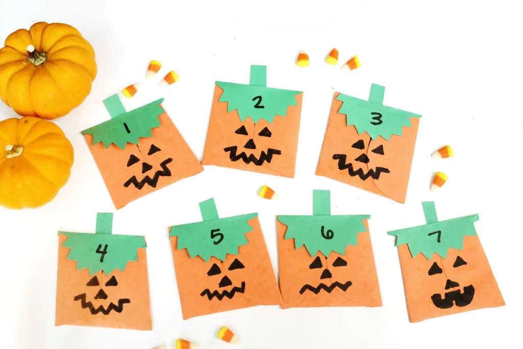 construction paper jack-o-lantern bags with treats inside
