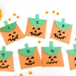 construction paper jack-o-lantern bags with treats inside