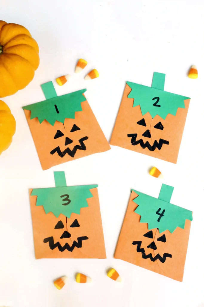 construction paper jack-o-lantern bags with treats inside