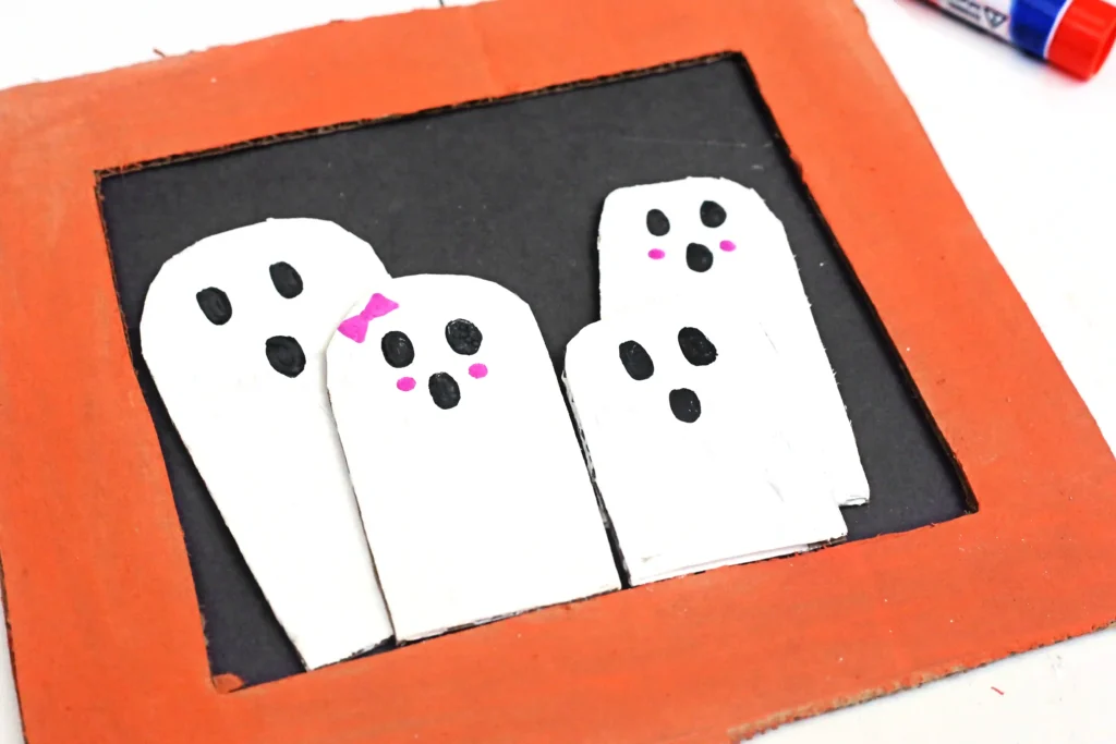 a Ghost Family Portrait Craft made out of cardboard and construction paper