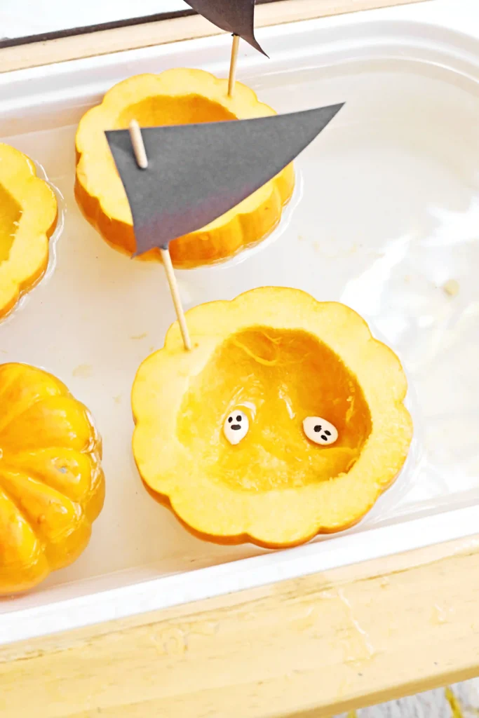 pumpkin seeds in a hollowed out pumpkin in water