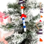 popsicle sticks painted and decorated to look like snowmen