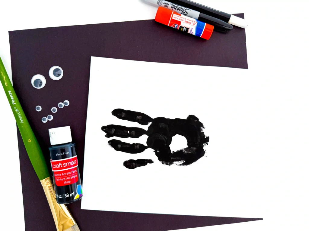 a black handprint on a piece of paper