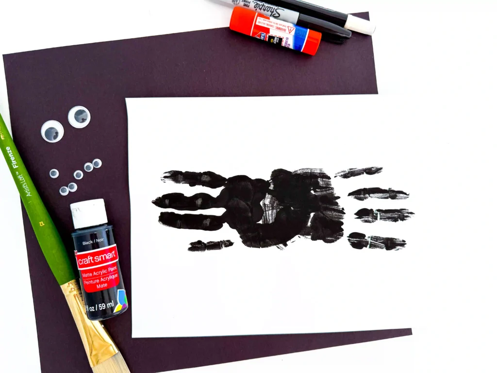 two black handprints on paper