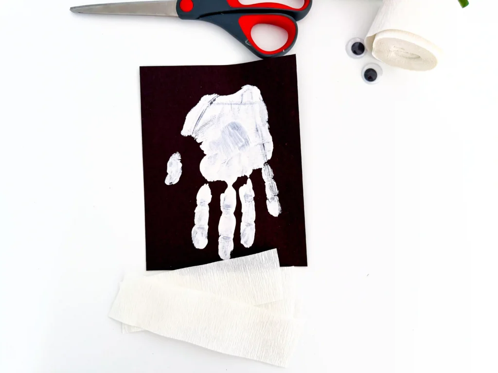 a white handprint on black paper
