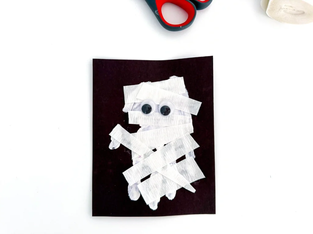 a Mummy Handprint Craft with streamer and googly eyes