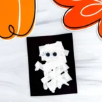 a Mummy Handprint Craft with streamer and googly eyes