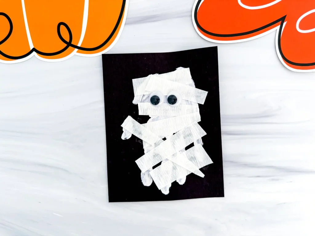 a Mummy Handprint Craft with streamer and googly eyes
