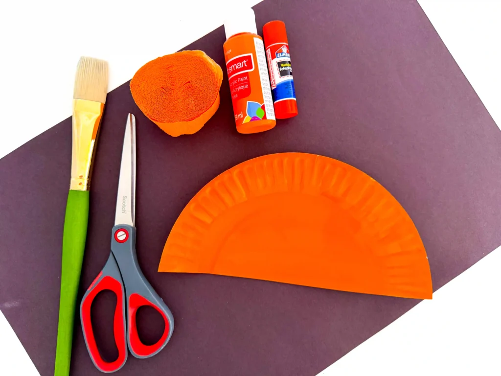 half of a paper plate painted orange