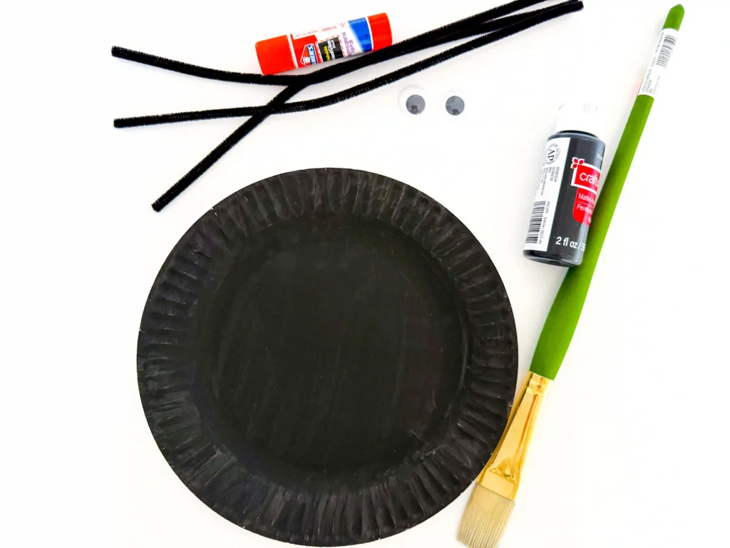 a paper plate painted black
