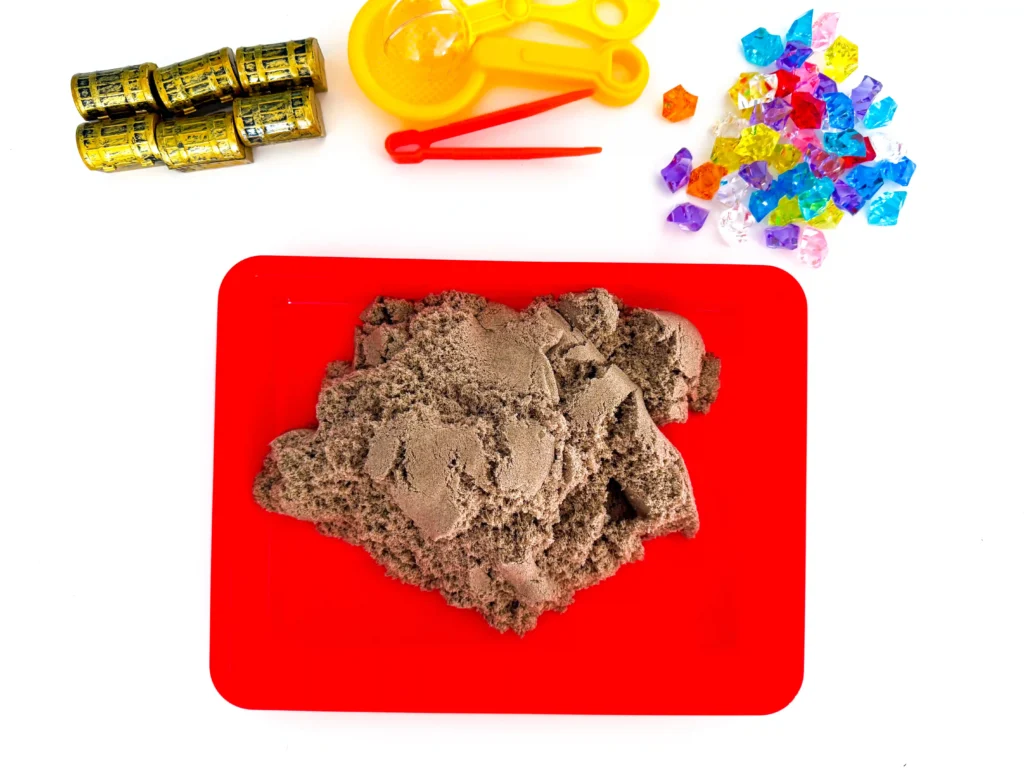 kinetic sand on a red tray