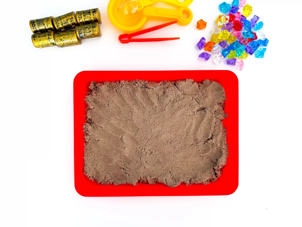 kinetic sand on a red tray