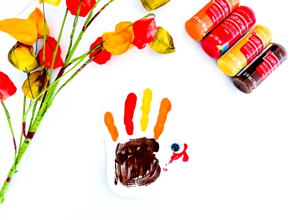 a turkey handprint craft of a painted handprint with googly eyes