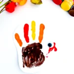 a turkey handprint craft of a painted handprint with googly eyes