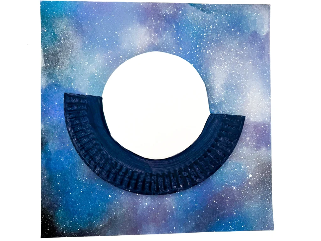 a paper plate cut to look like a ufo and painted black