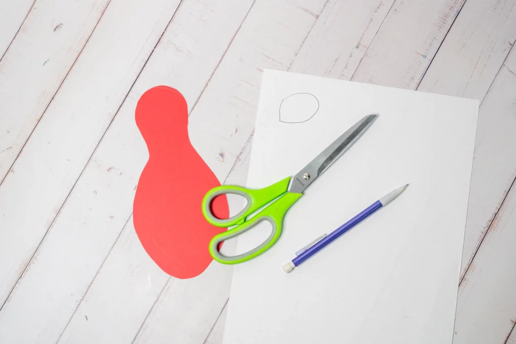 a parrot body cut out of red construction paper