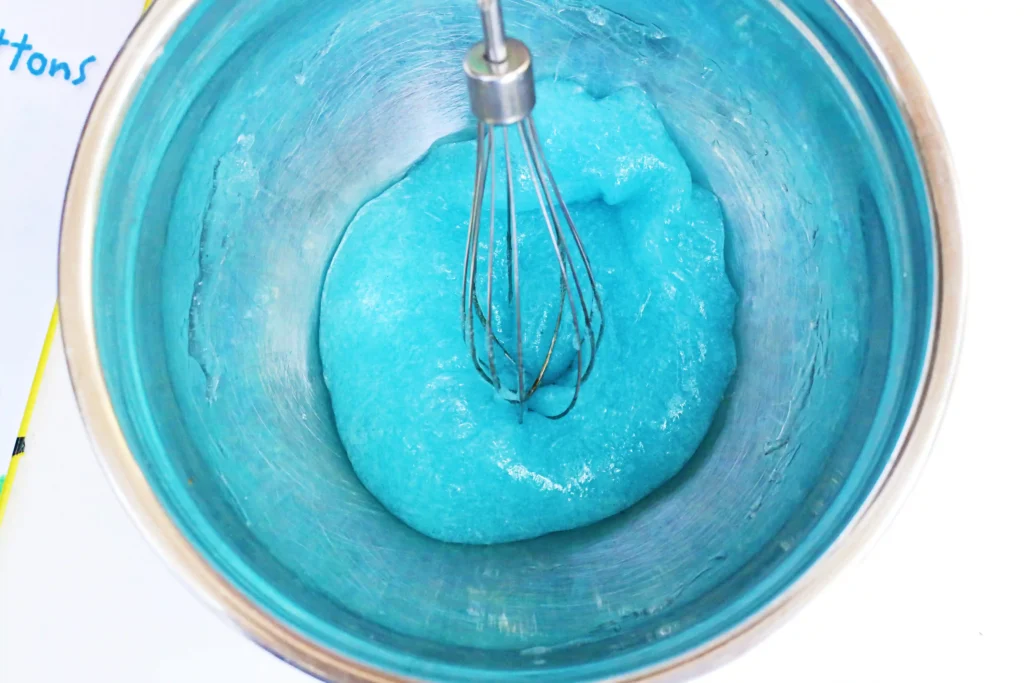 blue slime in a bowl with a whisk