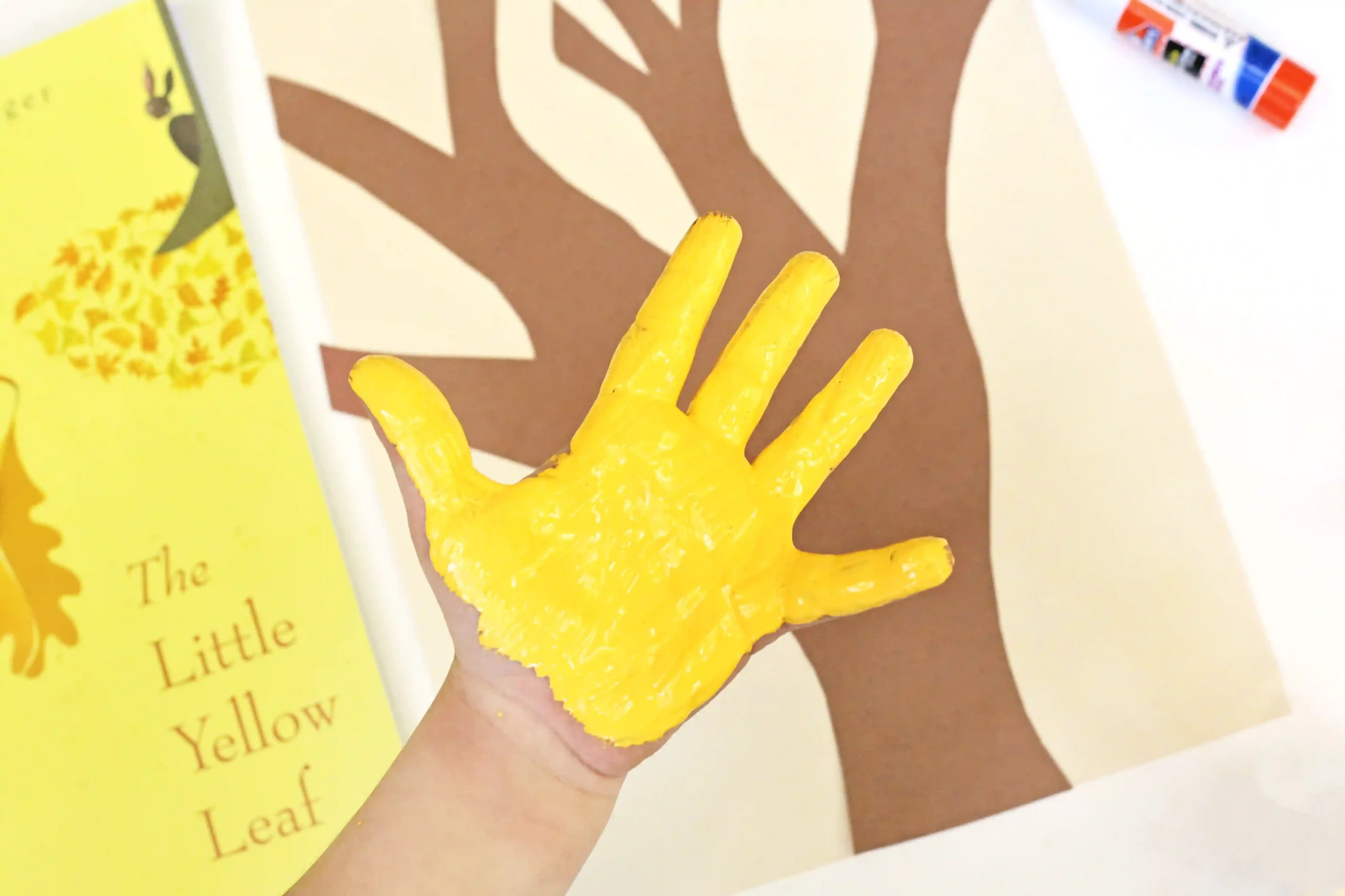 a kid's hand painted yellow