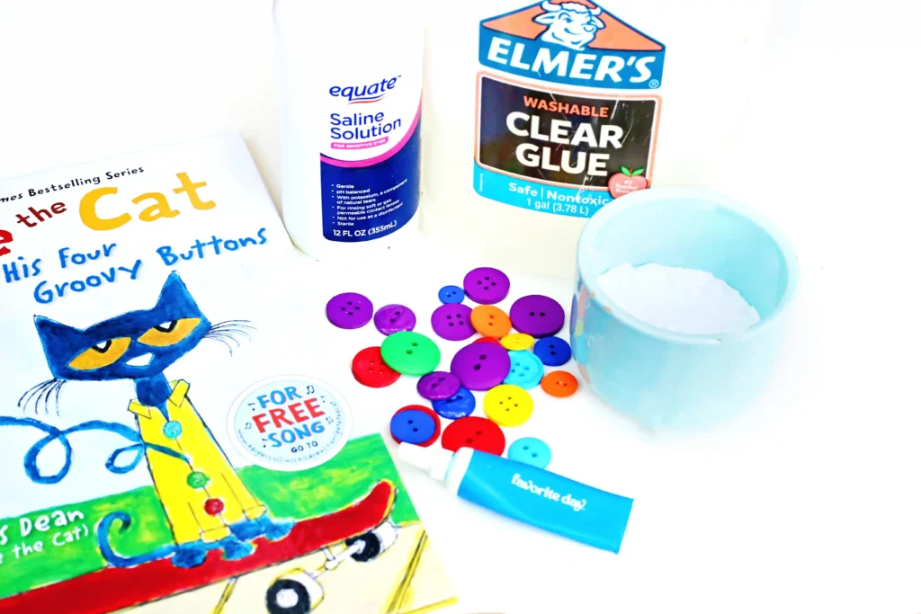 supplies for the pete the cat slime: glue, contact solution, water, buttons, and blue food gel