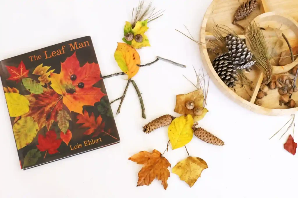 a man made out of leaves and sticks next to the book the leaf man