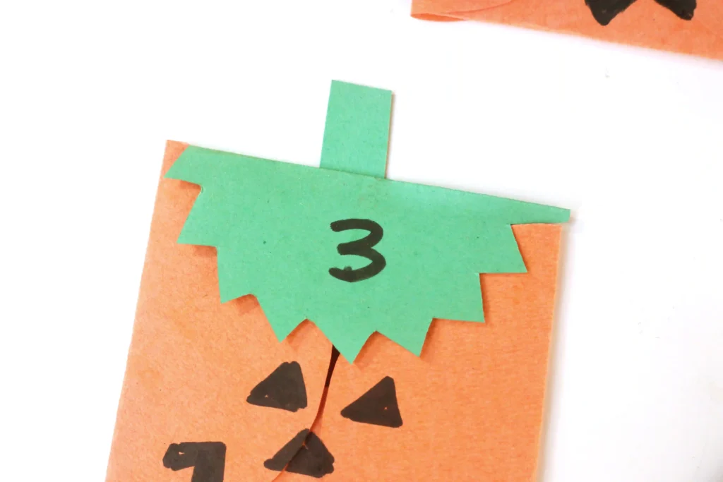 construction paper jack-o-lantern bags with treats inside