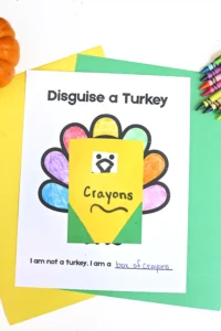 a print out of a turkey with construction paper on top that looks like a box of crayons