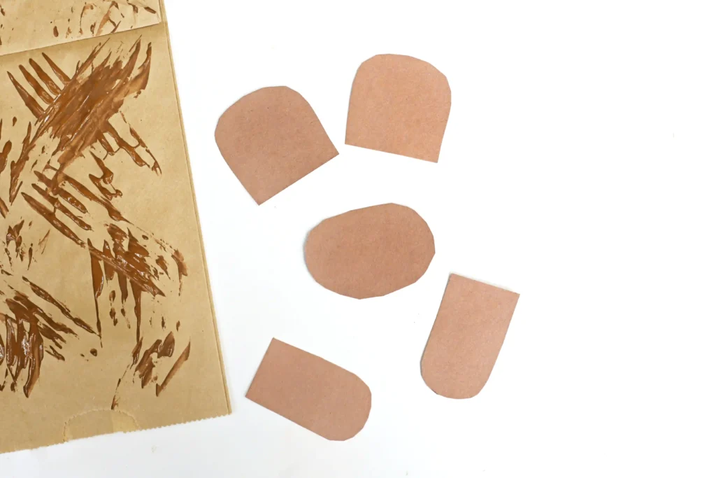 a bear snout, ears, and arms cut out of brown construction paper