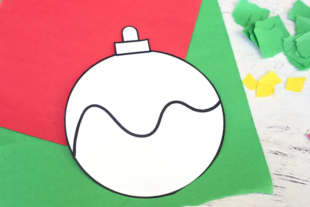 an ornament cut out of paper on a red and green background