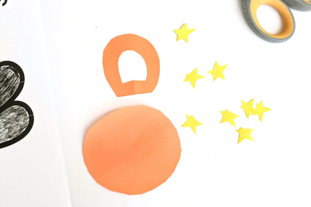 stars and an astronaut suit cut out of construction paper