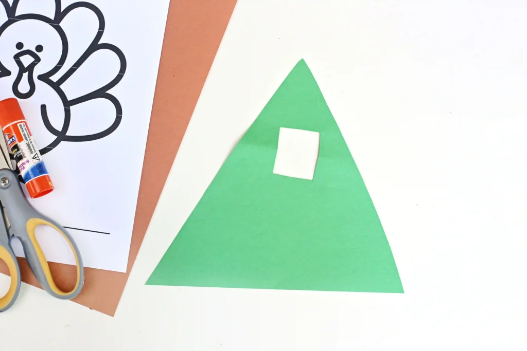 green construction paper cut into a triangle