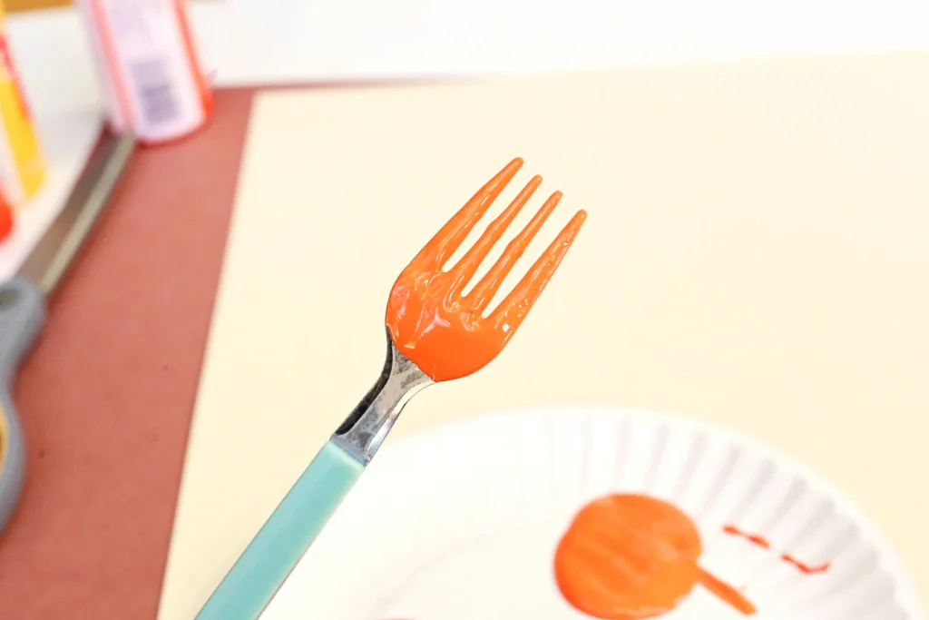 a fork with orange paint on it