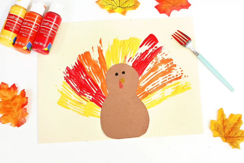 a turkey made out of construction paper with feathers painted on